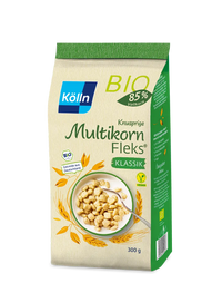 Die grün-beige Verpackung des Kölln Knusprige Multikorn Fleks von koelln enthält Bio-Getreide mit 85 % Vollkornanteil, wiegt 300 g und zeigt ein Müsli in einer Schale. Dieses vegane Produkt wird aus Getreide aus Deutschland hergestellt.
